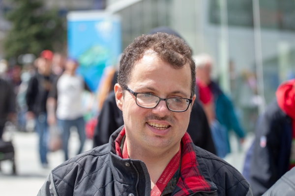 Male client smiling and walking down the street on an annual field trip outing.